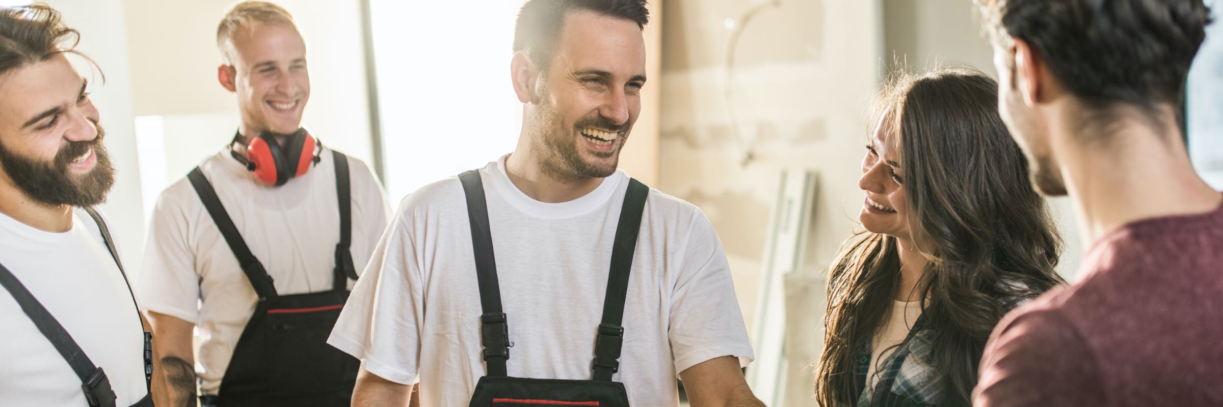 Group of contractors laughing with their customers